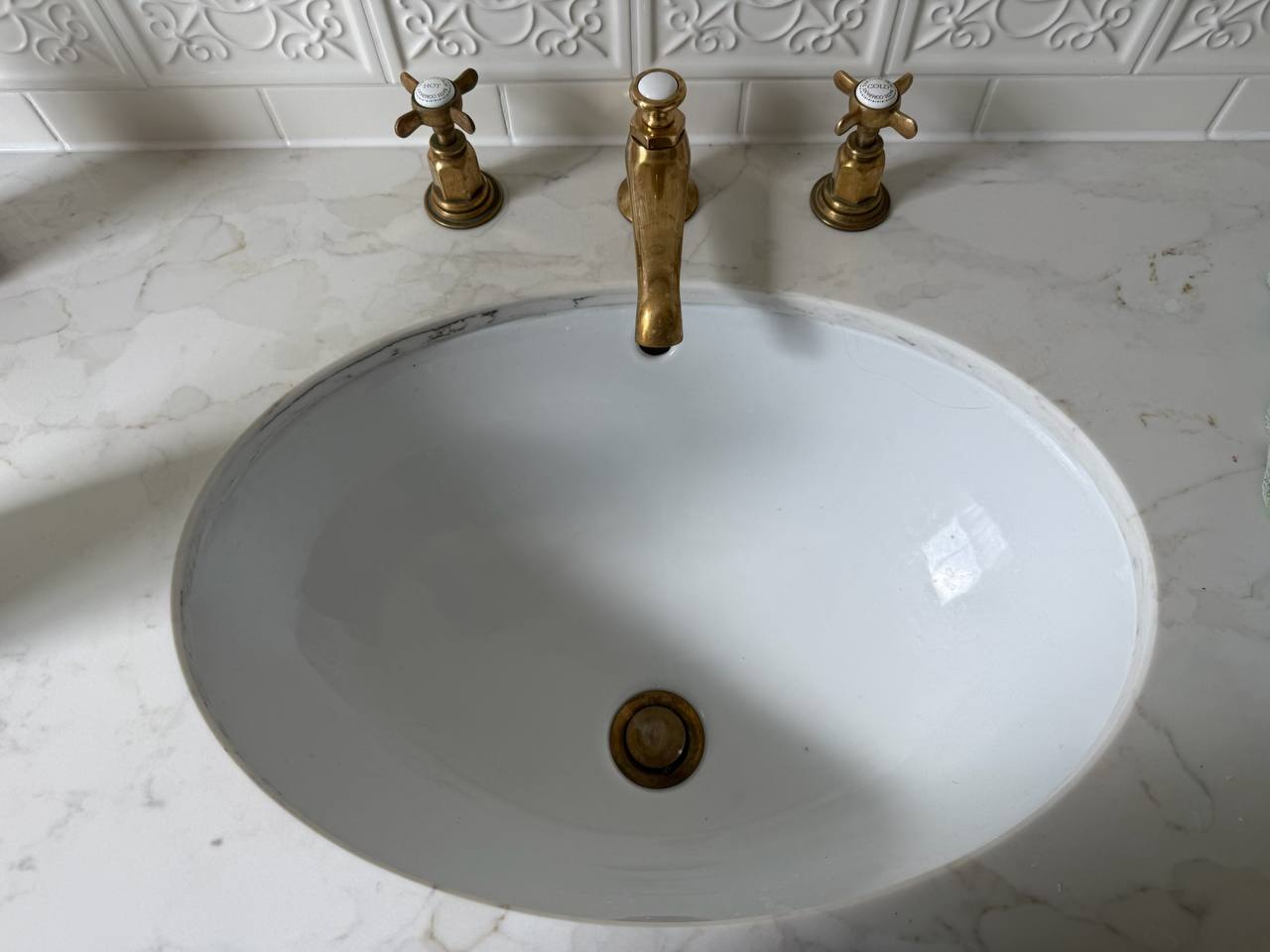 Gleaming bathroom sink and fixtures — before cleaning